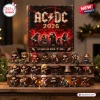 Front view of AC/DC 53rd Anniversary 2026 Advent Calendar box displayed above twenty-four numbered rock band figurines.
