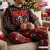 Front view of man wearing AC/DC High Voltage Christmas Sweater and Jogger Set holding a mug on a couch.