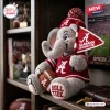Front view of an Alabama Crimson Tide plush elephant toy wearing a red jersey, pom-pom beanie, and holding a pennant and football.