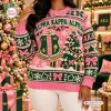 Front view of an Alpha Kappa Alpha Pink Ugly Christmas Sweater featuring a crest and holiday tree.