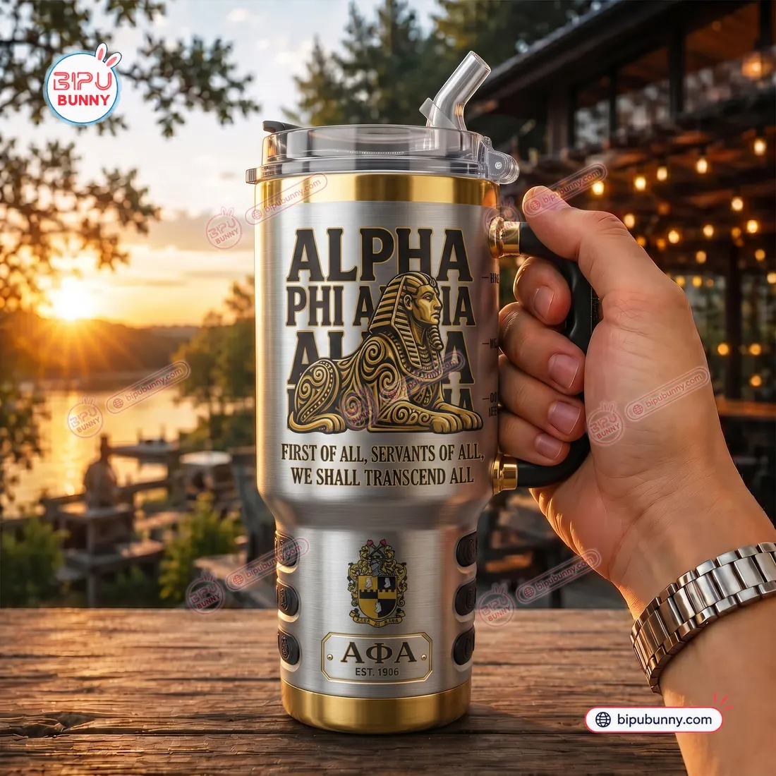 Outdoor view of the Alpha Phi Alpha Sphinx Stainless Steel Tumbler held by its black handle