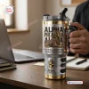 Close-up view of Alpha Phi Alpha Sphinx Stainless Steel Tumbler held in a desk setting.