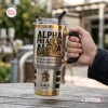 Hand holding an Alpha Phi Alpha Sphinx stainless steel tumbler with handle and straw.