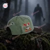 Side view of an olive green baseball cap featuring stitched details and a hockey mask graphic outdoors.