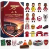Front view of an Arsenal FC Gunners Emirates Stadium 2026 Advent Calendar box alongside miniature figures and memorabilia.