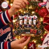 Closeup of hands holding the Atlanta Braves Let It Fly 2026 Christmas Ornament on a tree.
