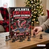 Front view of an Atlanta Falcons NFL Advent Calendar with mini figurines displayed on a wooden table.