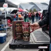 Hand holding Atlanta Falcons Rise Up 60th Anniversary Tumbler with matching box on a truck tailgate.