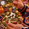 Closeup of Auburn Tigers Chris Davis Kick Six Christmas ornament hanging on a lit tree.