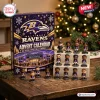 Front view of a Baltimore Ravens NFL Advent Calendar box beside small figurine displays on a wooden table.
