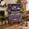 Front view of a Baltimore Ravens NFL Advent Calendar surrounded by small football player figurines on a wooden table.