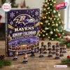 Front view of the Baltimore Ravens NFL Advent Calendar box with miniature player figures on a wooden table.