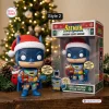 Front view of the Batman Holiday Lights Edition Vinyl Figure standing next to its retail box.