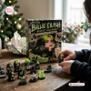 Close-up of Billie Eilish Christmas Advent Calendar box with figures displayed on table.