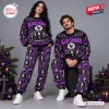 Front view of a couple wearing matching black and purple Black Sabbath Christmas ugly sweater and pants sets.