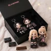 Top view of BLACKPINK 10th Anniversary Tour Plush Keychain Set in a black gift box with name stands.