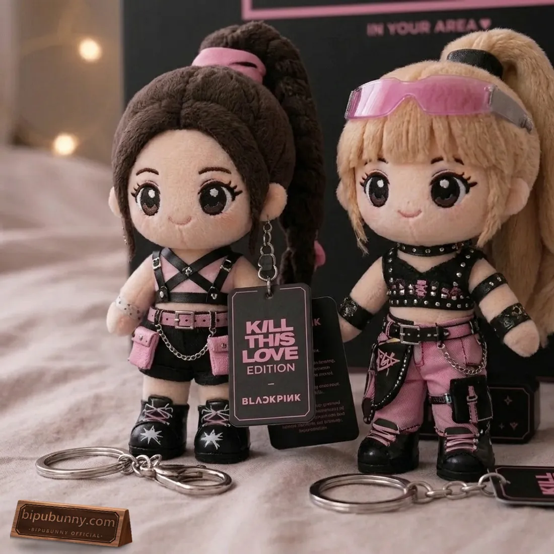 Close-up of Jennie and Lisa Kill This Love Iconic Warrior Edition plush keychains showing tactical chest harness, pink cargo pants, visor glasses, and silver lobster clasps