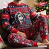 Person wearing red and blue holiday sweater and jogger set with rock music graphics.