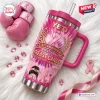 Pink handle tumbler with 41st anniversary breast cancer graphics, resting on white fur.
