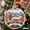 Close-up of Brisbane Lions AFL 2026 Three-Peat Glass Ornament hanging on tree.