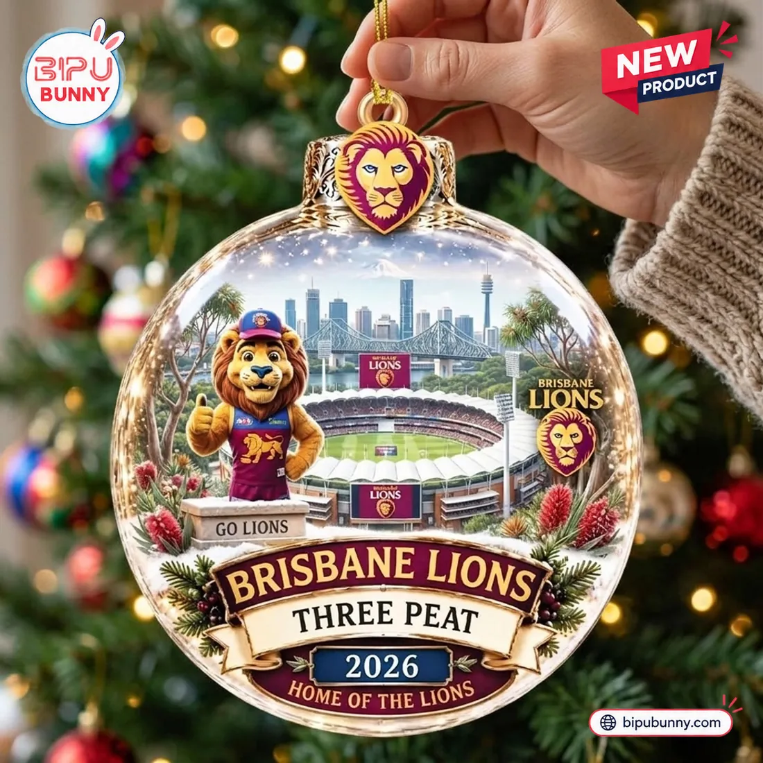 Hand holding the Brisbane Lions AFL 2026 Three-Peat glass Christmas ornament