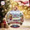 Close-up of a round glass ornament featuring a stadium scene with a lion mascot and Brisbane Lions AFL 2026 Three-Peat text.