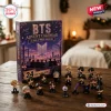 Front view of BTS Advent Calendar Figurine Set box with tiny chibi figures arranged on a wooden table.