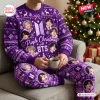Front view of a person wearing a purple BTS Christmas sweater and matching plaid jogger pants set holding a mug.