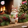 Front view of a bunny figurine wearing Santa attire holding a gift, part of the Bunny Christmas 2026 Advent Calendar collection.