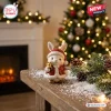 Front view of a white ceramic bunny wearing a red Santa outfit holding a golden bell.