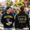 Two people wearing a California Golden Bears Grateful Dead black hoodie outdoors.