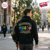 Back view of a person wearing a California Golden Bears Grateful Dead black hoodie on a campus walkway.