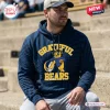 Man wearing a California Golden Bears Grateful Dead Pullover Hoodie while sitting outdoors.