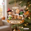 Hanging Christmas ornament depicting Charlie Brown holding a rock with friends in costume, featured on a tree.