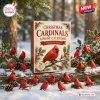Front view of the Christmas Cardinals 2026 Advent Calendar box surrounded by red bird figurines on a snowy log.