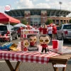 Chuck Amato North Carolina State University vinyl figure on a tailgate table.