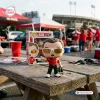 Front view of Chuck Amato North Carolina State University vinyl figure on a wooden picnic table.