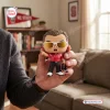 Hand holding a Chuck Amato North Carolina State University vinyl figure wearing sunglasses and a red shirt.