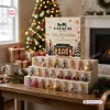 Front view of Coach New York Advent Calendar 2026 with twenty-four charms displayed on tiered stands.