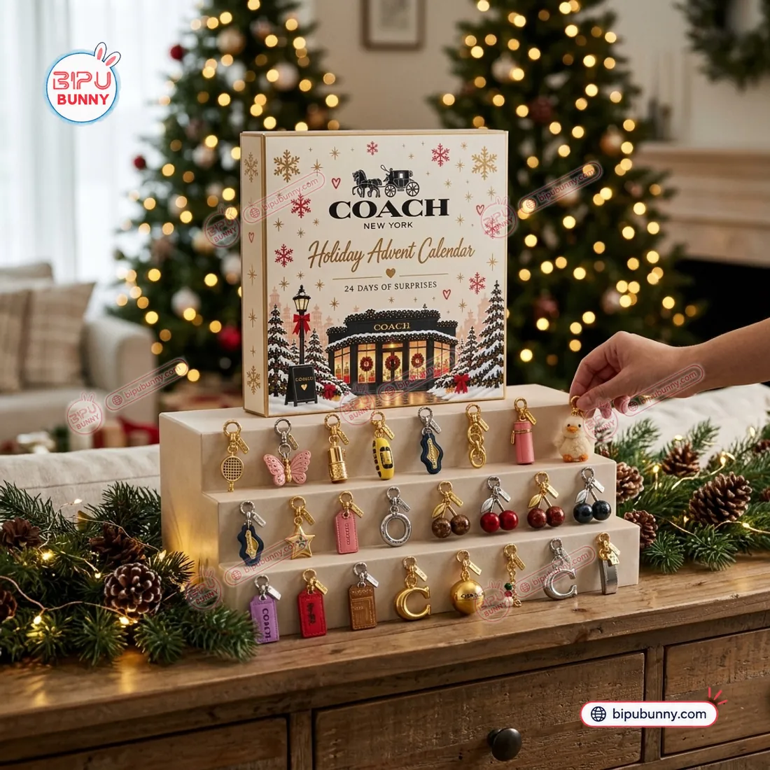 Holding the plush duckling bag charm beside the Coach New York Advent Calendar 2026 box and pine garland