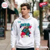 Man wearing white Coastal Carolina Chanticleers 90s Friday Night Hoodie outdoors on a city sidewalk.