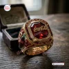 Closeup of the Coca-Cola 140th Anniversary 1886 - 2026 Ring resting on a wooden table.