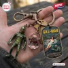 Closeup of Creature From The Black Lagoon Gill Man Keychain held in hand with charms.