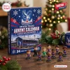 Front view of the Crystal Palace FC Advent Calendar box next to small player figurines.