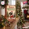 Front view of a Dachshund Christmas advent calendar box with a small dog figurine on a mantelpiece.