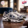 Side view of Dallas Cowboys AT&T Stadium Air Max Plus Sneakers with rhinestones on hardwood floor.