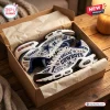 Unboxing view of Dallas Cowboys AT&T Stadium Air Max Plus Sneakers in a shoebox.