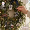 Close-up view of a hand hanging a star ornament on a Christmas wreath featuring team-themed decorations.