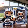 Front view of the Dallas Cowboys Cornell Green vinyl figure standing outside its branded box on a wooden table.
