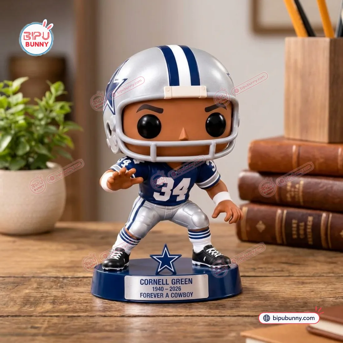 Out of box close up of the freestanding Cornell Green number 34 Dallas Cowboys vinyl figure on a wooden desk beside leather bound books